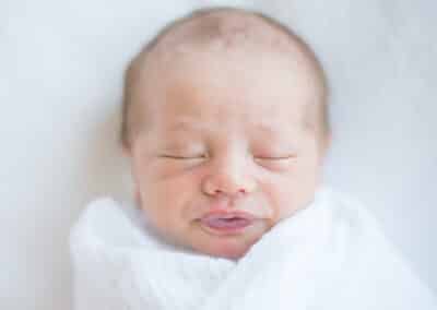 a newborn baby rests peacefully photographed in a minimalist way