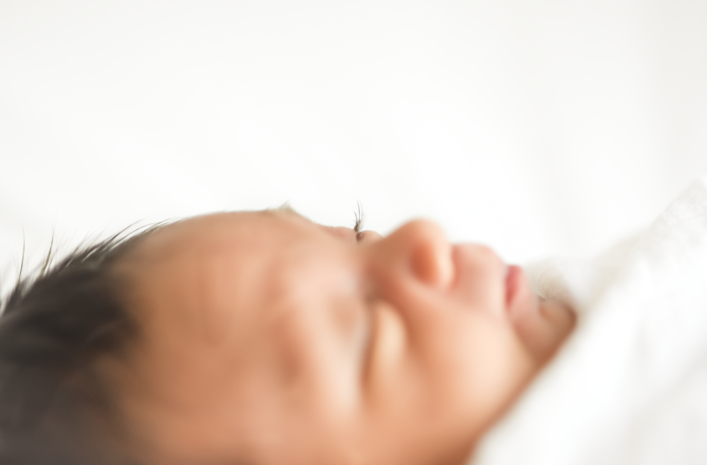 a close up a newborn's lashes are highlighted 