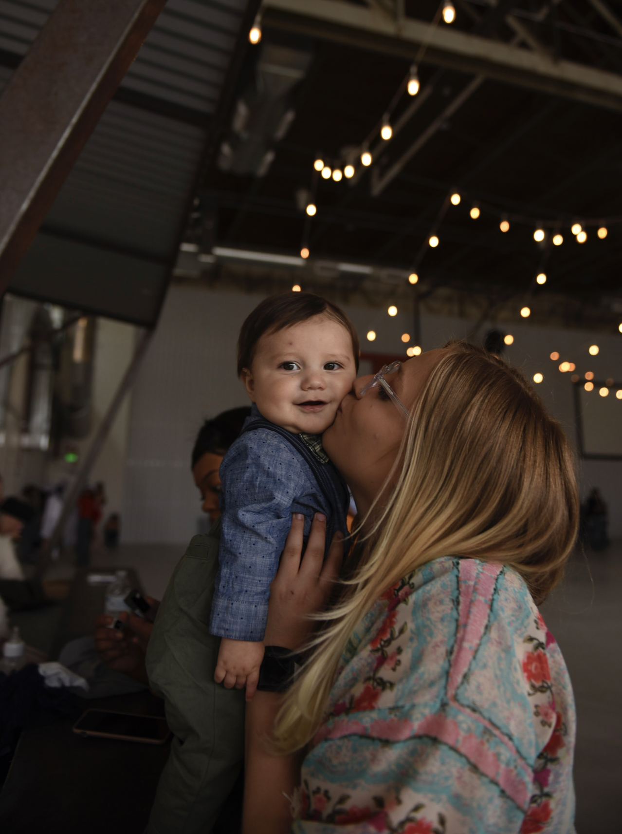 giving back a senior session - a senior poses with her young son